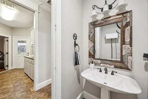 a kitchen with granite countertop white cabinets and sink