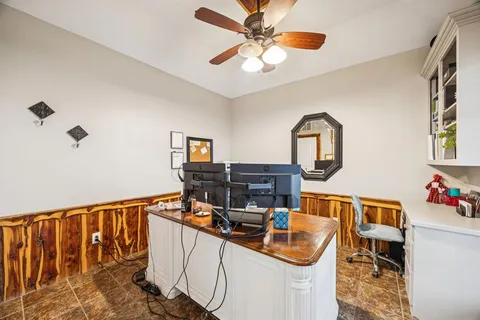 a dining room with furniture and a floor to ceiling window