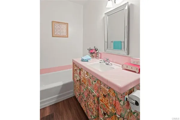 a bathroom with a double vanity sink and a mirror