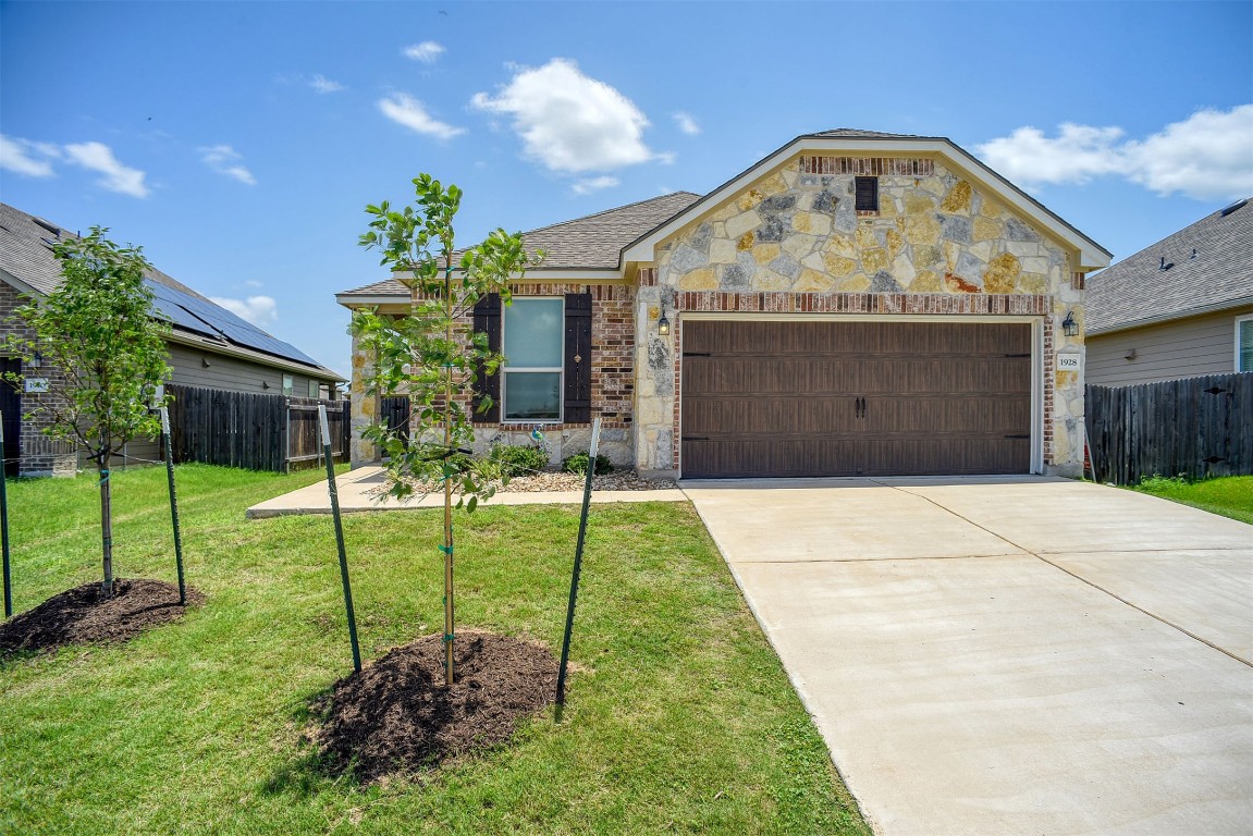 1928 Dragonfly Loop Bastrop, TX 78602 - Photo 13 of 32 a front view of a house with a yard