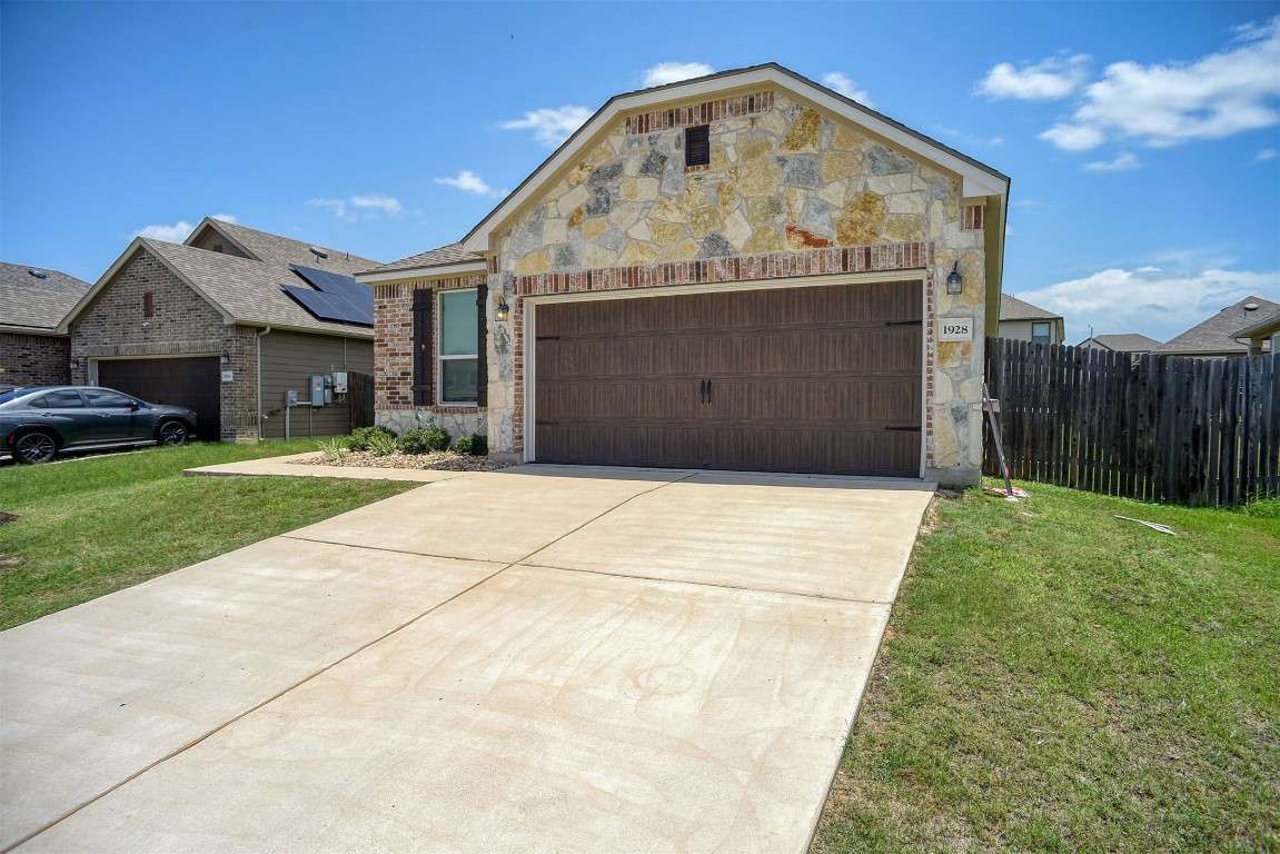 1928 Dragonfly Loop Bastrop, TX 78602 - Photo 14 of 32 a front view of a house with garden