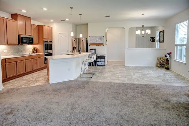 a kitchen with stainless steel appliances a sink and a refrigerator