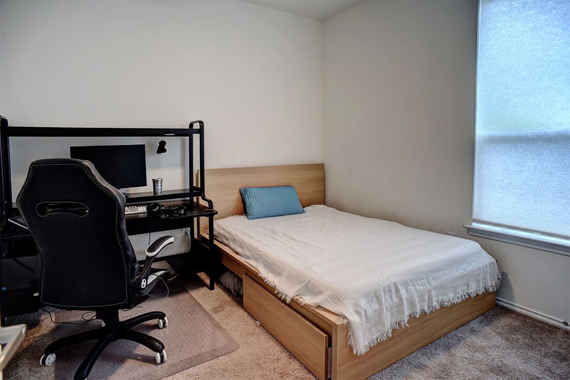 1928 Dragonfly Loop Bastrop, TX 78602 - Photo 25 of 32 a bedroom with a bed and a desk