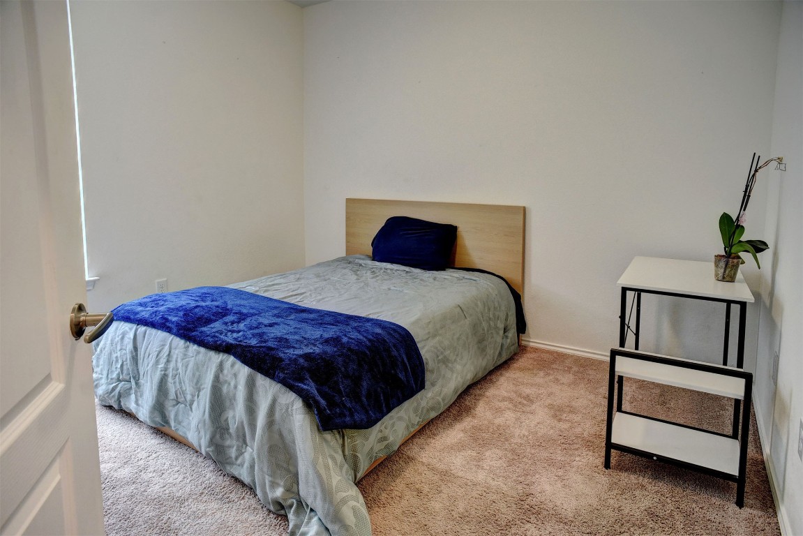 1928 Dragonfly Loop Bastrop, TX 78602 - Photo 26 of 32 a bedroom with a bed and a dresser