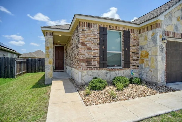 a kitchen with cabinets and chairs