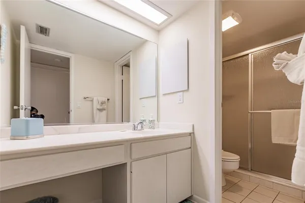 a bathroom with a double vanity sink toilet and shower