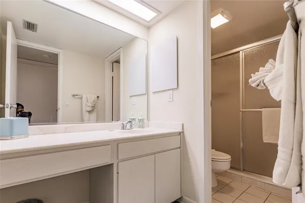 a bathroom with a double vanity sink toilet and shower