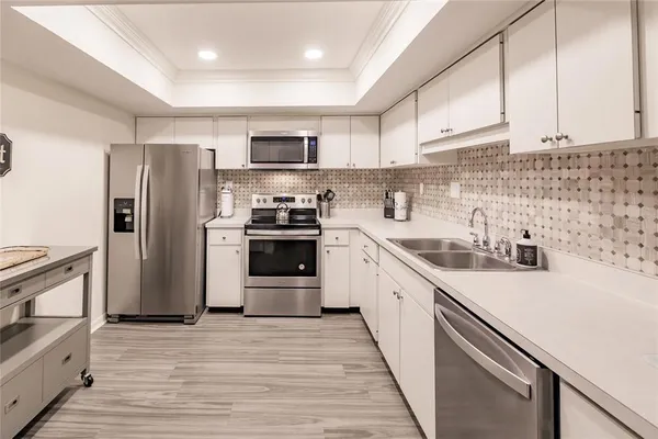 a kitchen with stainless steel appliances a refrigerator stove and sink
