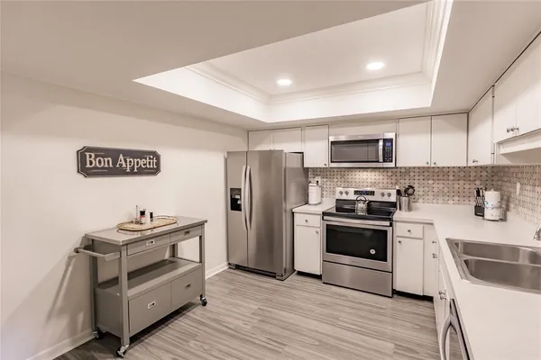 a kitchen with granite countertop a refrigerator stove and oven