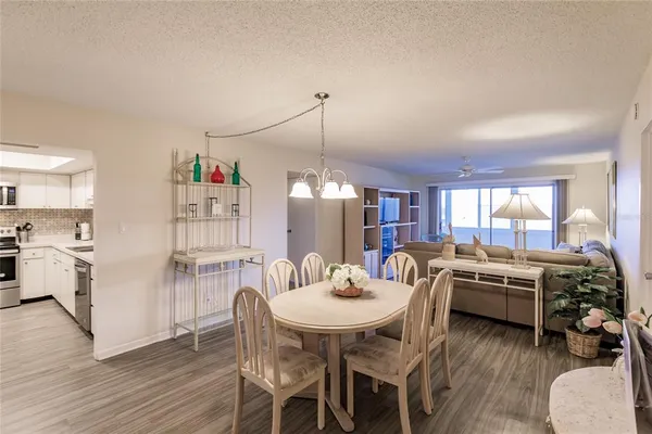 a view of a dining room with furniture and wooden floor