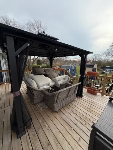 a view of a roof deck with wooden floor and barbeque oven