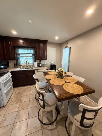a large kitchen with lots of counter top space a sink and appliances