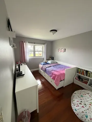 a bedroom with bed and window