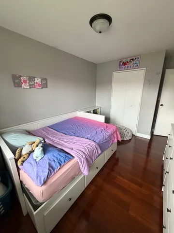 a bedroom with bed and a mirror