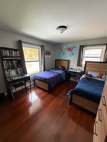 a bedroom with two beds and a couch