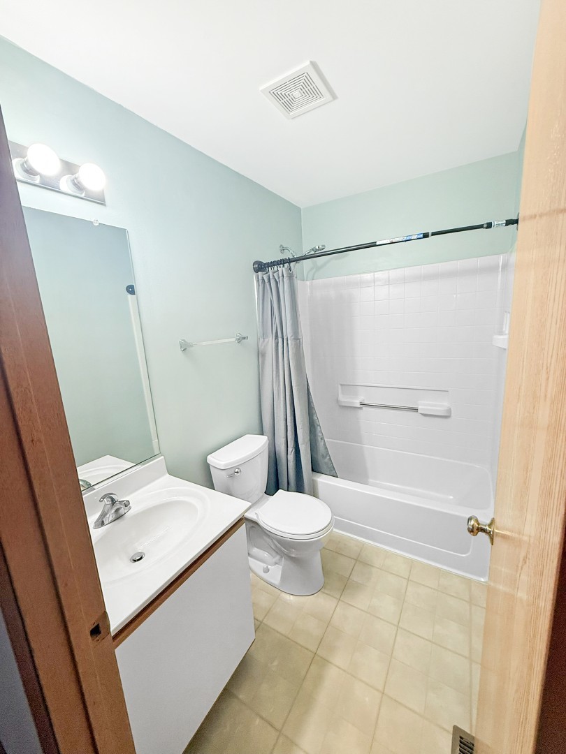 1533 Keystone Court Elgin, IL 60120 - Photo 13 of 15 a bathroom with a sink a toilet and shower