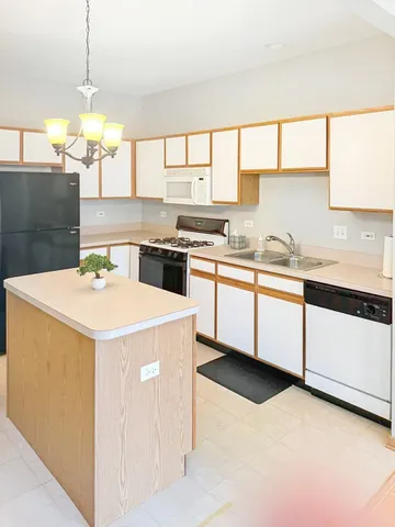 a kitchen that has a sink and a stove in it