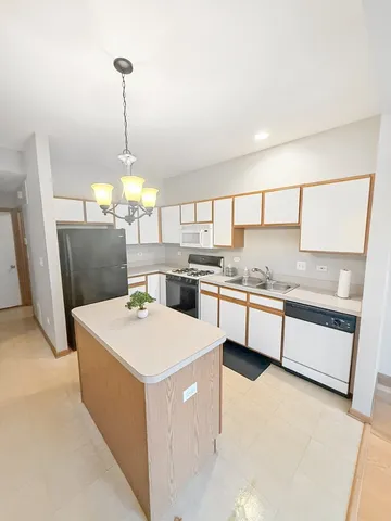 a kitchen with a sink a counter top space and appliances