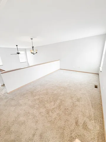 a view of a refrigerator in an empty room
