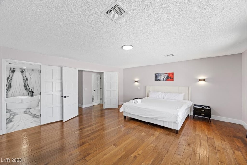 5110 Evaline Street Las Vegas, NV 89120 - Photo 11 of 55 Generous primary retreat featuring a fireplace and elegant spa-like ensuite.