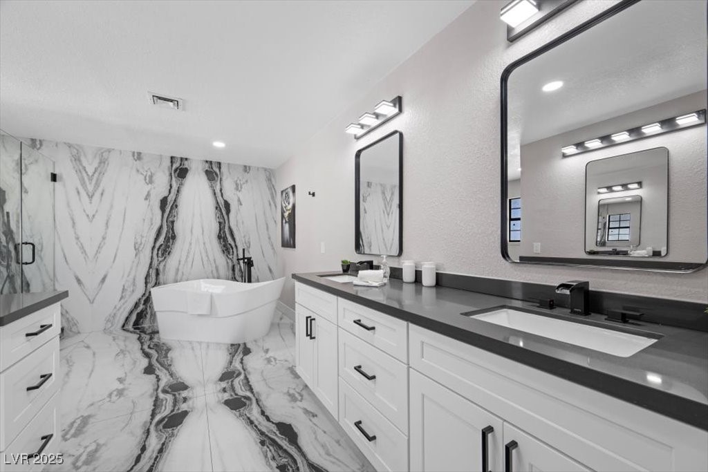 5110 Evaline Street Las Vegas, NV 89120 - Photo 12 of 55 Spacious ensuite with dual vanities, soaking tub, and walk-in shower.