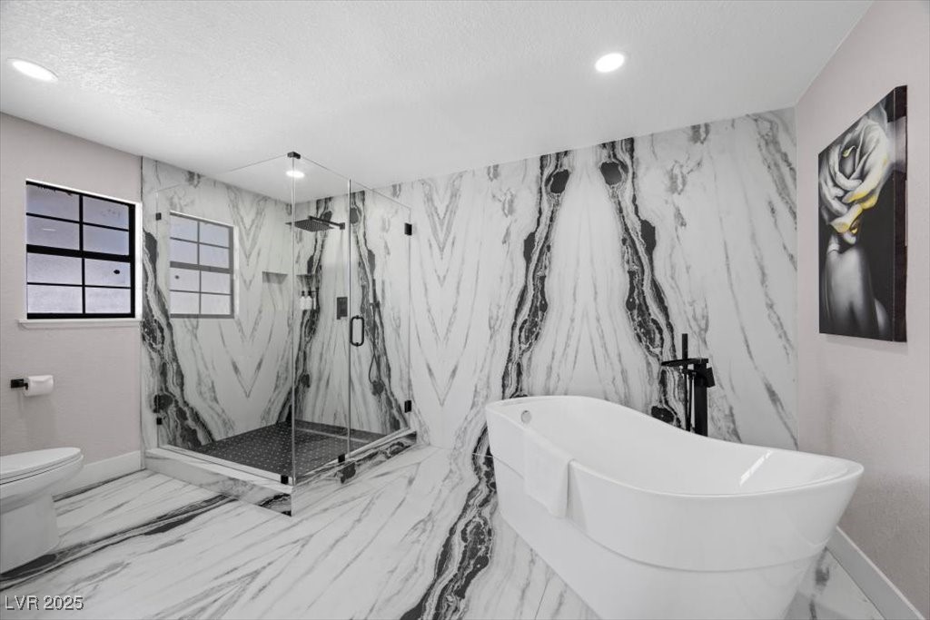 5110 Evaline Street Las Vegas, NV 89120 - Photo 13 of 55 Luxurious primary bath features a spacious layout with a soaking tub and a sleek, separate shower for ultimate relaxation.