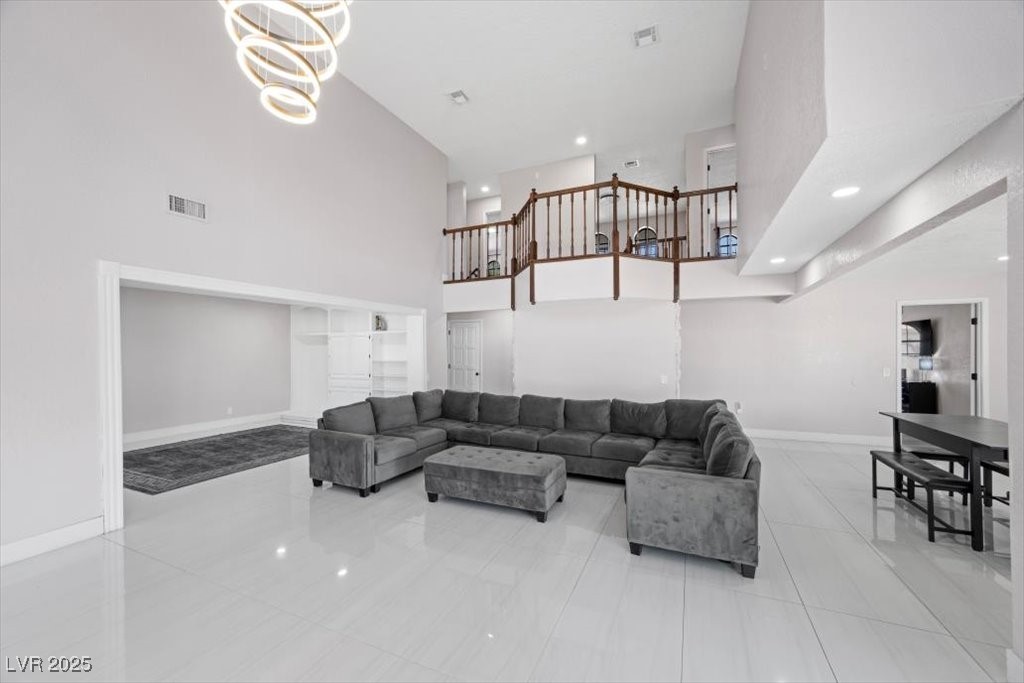 5110 Evaline Street Las Vegas, NV 89120 - Photo 4 of 55 The living room features impressive ceiling height paired with a dazzling chandelier centerpiece!