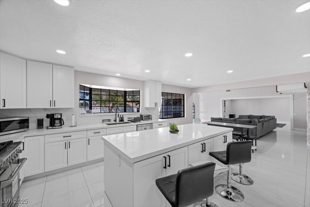 5110 Evaline Street Las Vegas, NV 89120 - Photo 7 of 55 Kitchen with open layout offers smooth transitions to dining area and living room.