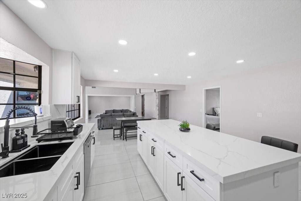 5110 Evaline Street Las Vegas, NV 89120 - Photo 9 of 55 The open-concept design effortlessly connects the kitchen and living room, making entertaining and everyday living a breeze.