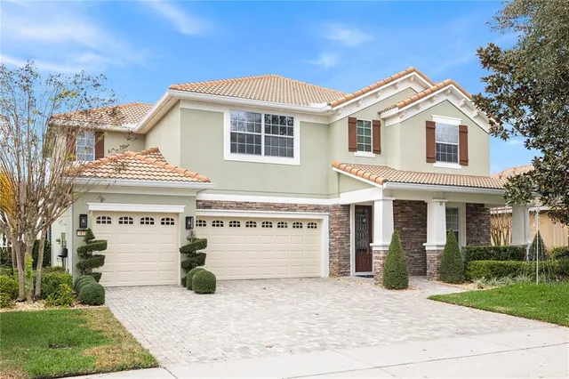 a view of a white building with a big yard and potted plants