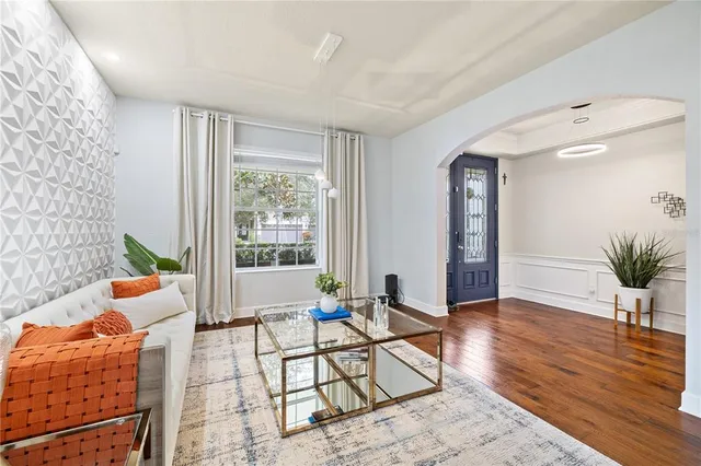 a living room with furniture and a wooden floor