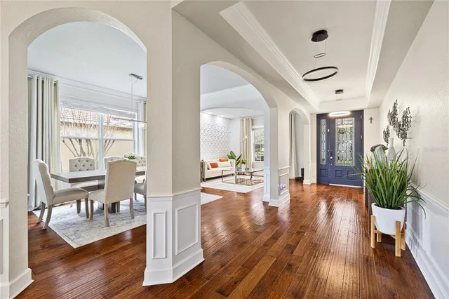 a kitchen with stainless steel appliances granite countertop a sink a stove a refrigerator and island with wooden floor