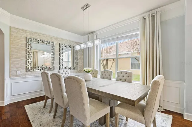 a kitchen with stainless steel appliances granite countertop a sink a stove and a wooden floors