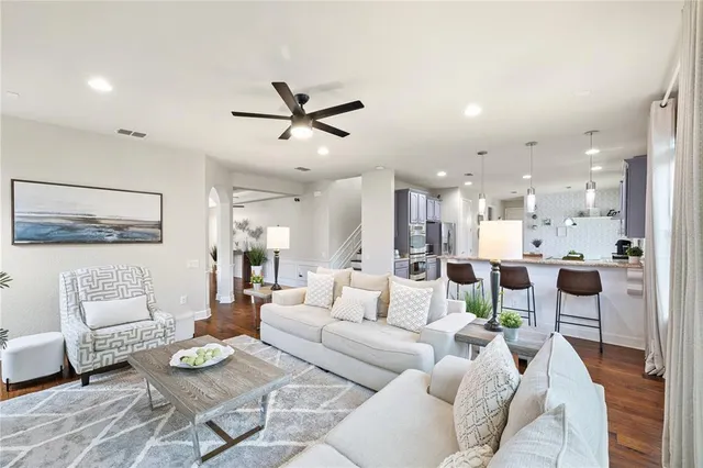 a living room with furniture and a potted plant