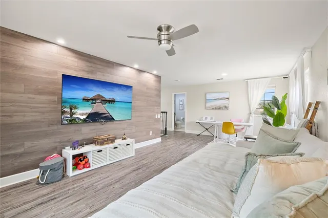 a view of a patio with table and chairs and floor to ceiling window