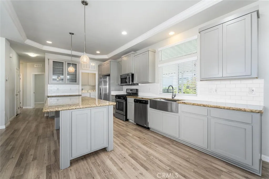 16222 Monterey Lane, Unit 285 Huntington Beach, CA 92649 - Photo 12 of 59 a kitchen with granite countertop a sink counter space cabinets and stainless steel appliances