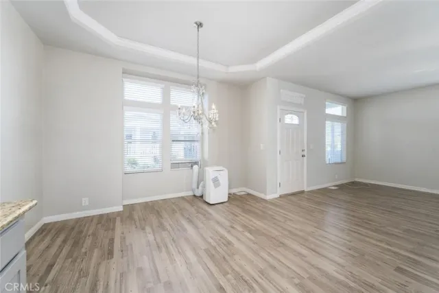 an empty room with windows and ceiling fan