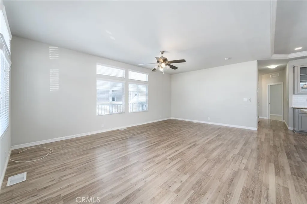 16222 Monterey Lane, Unit 285 Huntington Beach, CA 92649 - Photo 19 of 59 wooden floor in an empty room with a window