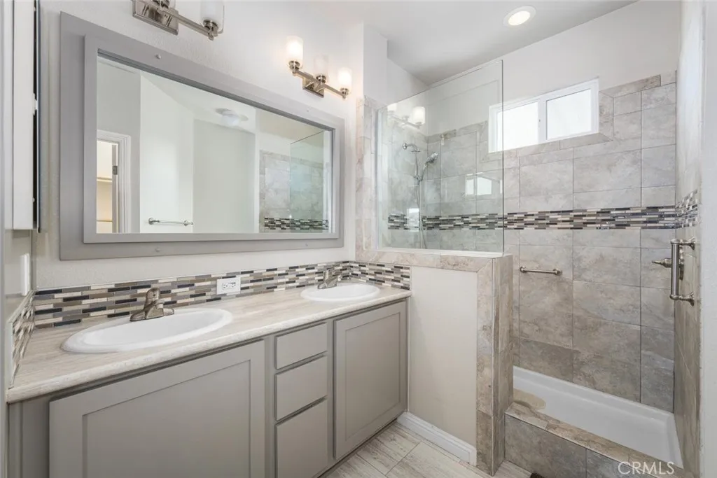 16222 Monterey Lane, Unit 285 Huntington Beach, CA 92649 - Photo 22 of 59 a bathroom with a sink and a mirror