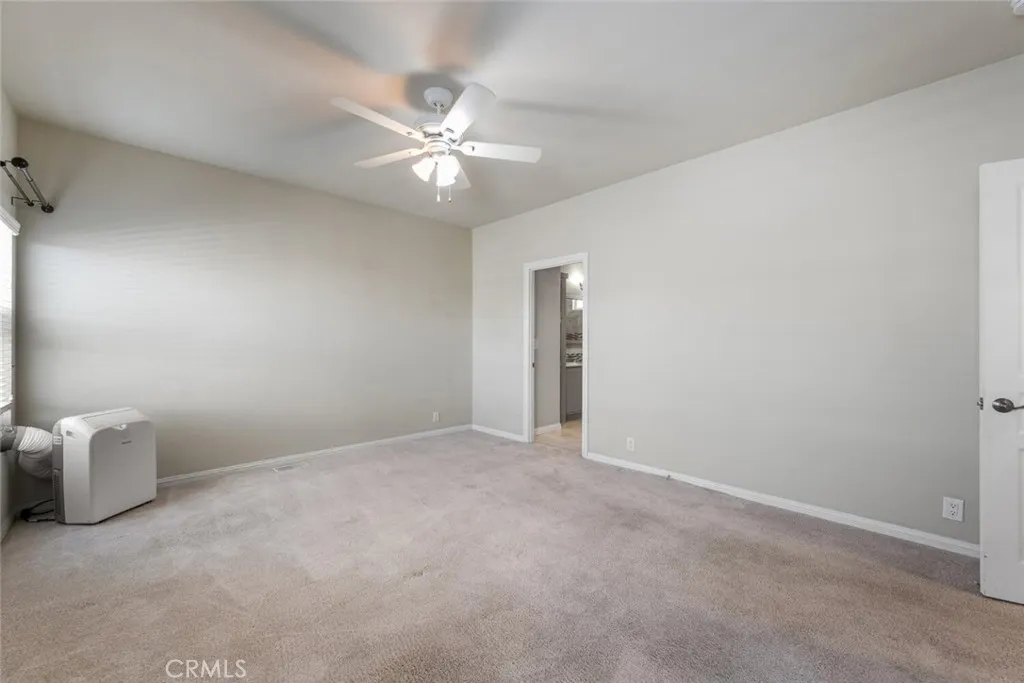 16222 Monterey Lane, Unit 285 Huntington Beach, CA 92649 - Photo 25 of 59 an empty room with windows and fan