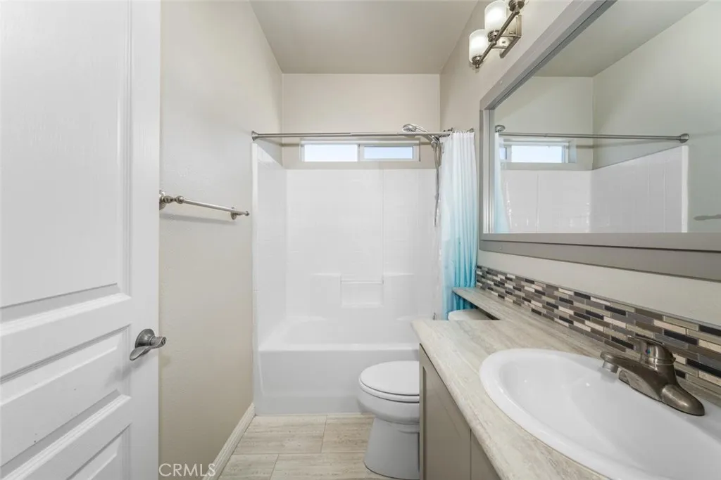 16222 Monterey Lane, Unit 285 Huntington Beach, CA 92649 - Photo 29 of 59 a bathroom with a granite countertop sink toilet and shower