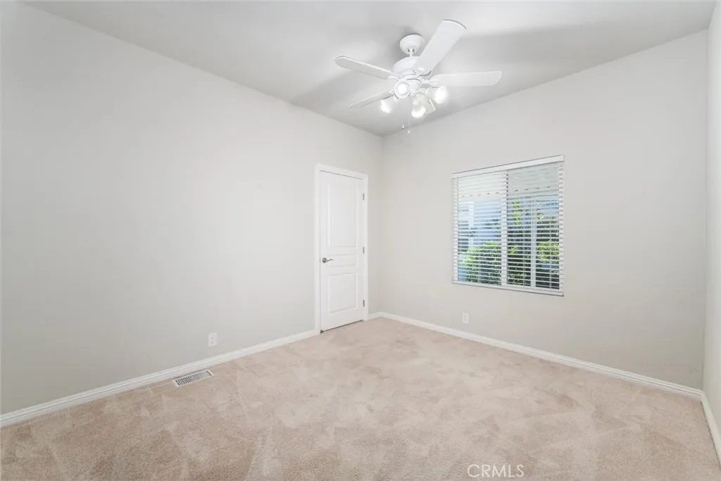 16222 Monterey Lane, Unit 285 Huntington Beach, CA 92649 - Photo 30 of 59 an empty room with a chandelier fan