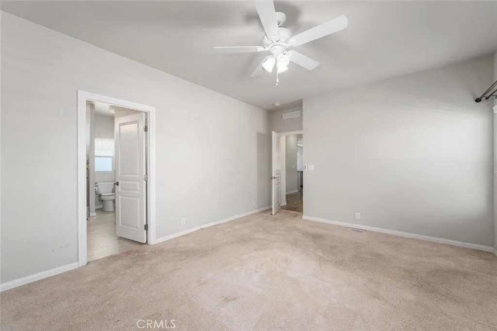 16222 Monterey Lane, Unit 285 Huntington Beach, CA 92649 - Photo 34 of 59 an empty room with a ceiling fan and bathroom