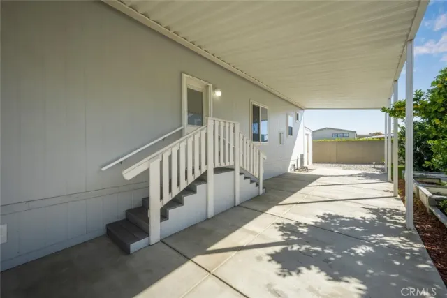 a view of a hallway with wooden floor and entryway