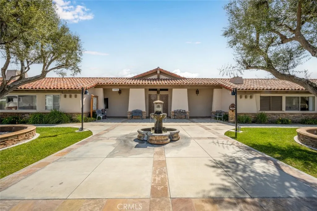 16222 Monterey Lane, Unit 285 Huntington Beach, CA 92649 - Photo 50 of 59 a front view of a house with a yard