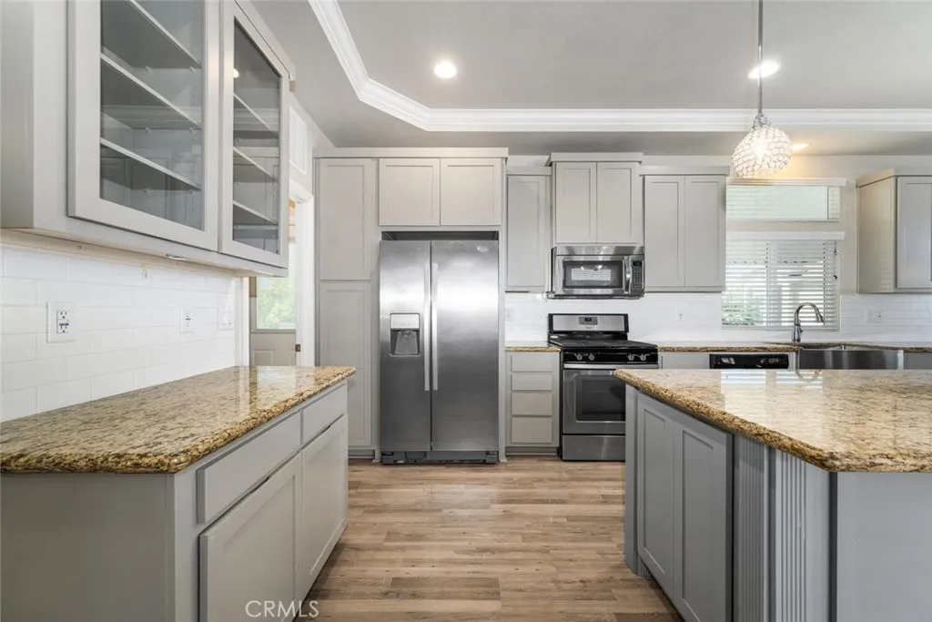 16222 Monterey Lane, Unit 285 Huntington Beach, CA 92649 - Photo 5 of 59 a kitchen with stainless steel appliances granite countertop a sink and a refrigerator