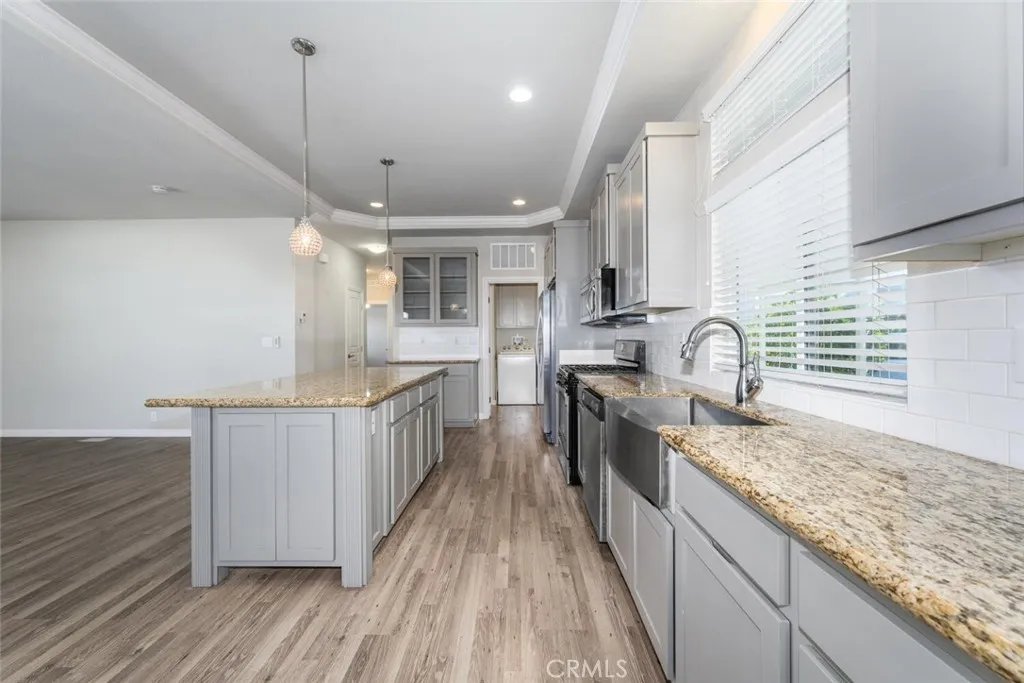 16222 Monterey Lane, Unit 285 Huntington Beach, CA 92649 - Photo 6 of 59 a kitchen with stainless steel appliances granite countertop wooden cabinets a sink dishwasher a stove and a refrigerator