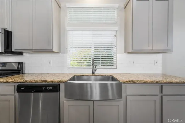 a stove top oven sitting inside of a kitchen