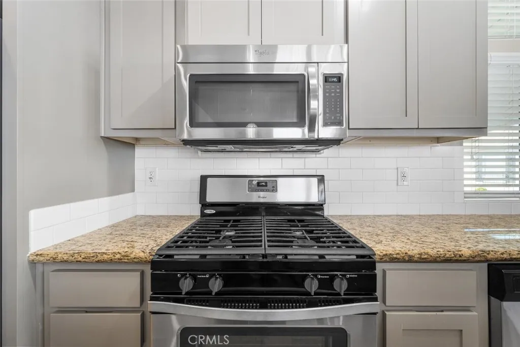 16222 Monterey Lane, Unit 285 Huntington Beach, CA 92649 - Photo 9 of 59 a stove top oven sitting inside of a kitchen