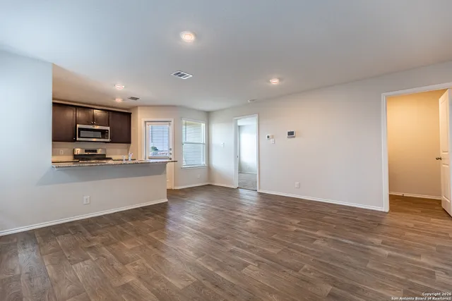 a view of kitchen with microwave oven and cabinets